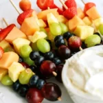 Fresh Fruit Kabobs with Cinnamon Dip: The Ultimate Colorful Snack for Parties and Family Fun 9 Colorful fresh fruit kabobs served with a cinnamon dip for a tasty treat.