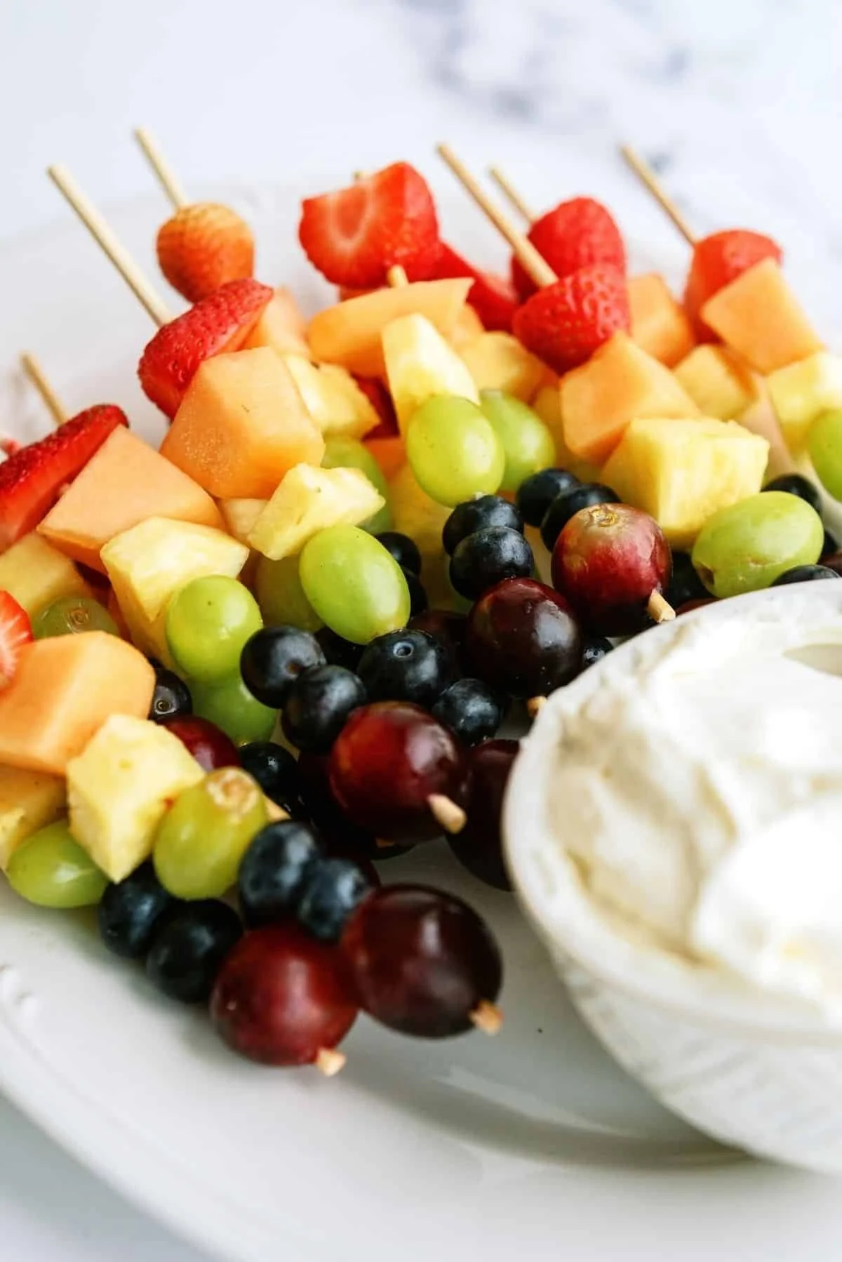 Colorful fresh fruit kabobs served with a cinnamon dip for a tasty treat.
