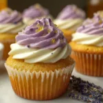 A beautifully decorated lavender honey cupcake topped with lavender sprigs and honey drizzle