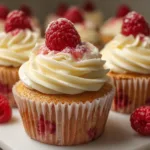 Delicious white chocolate raspberry cupcakes topped with creamy frosting and fresh raspberries